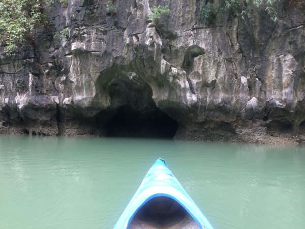 My sister on the kayak heading towards a cave